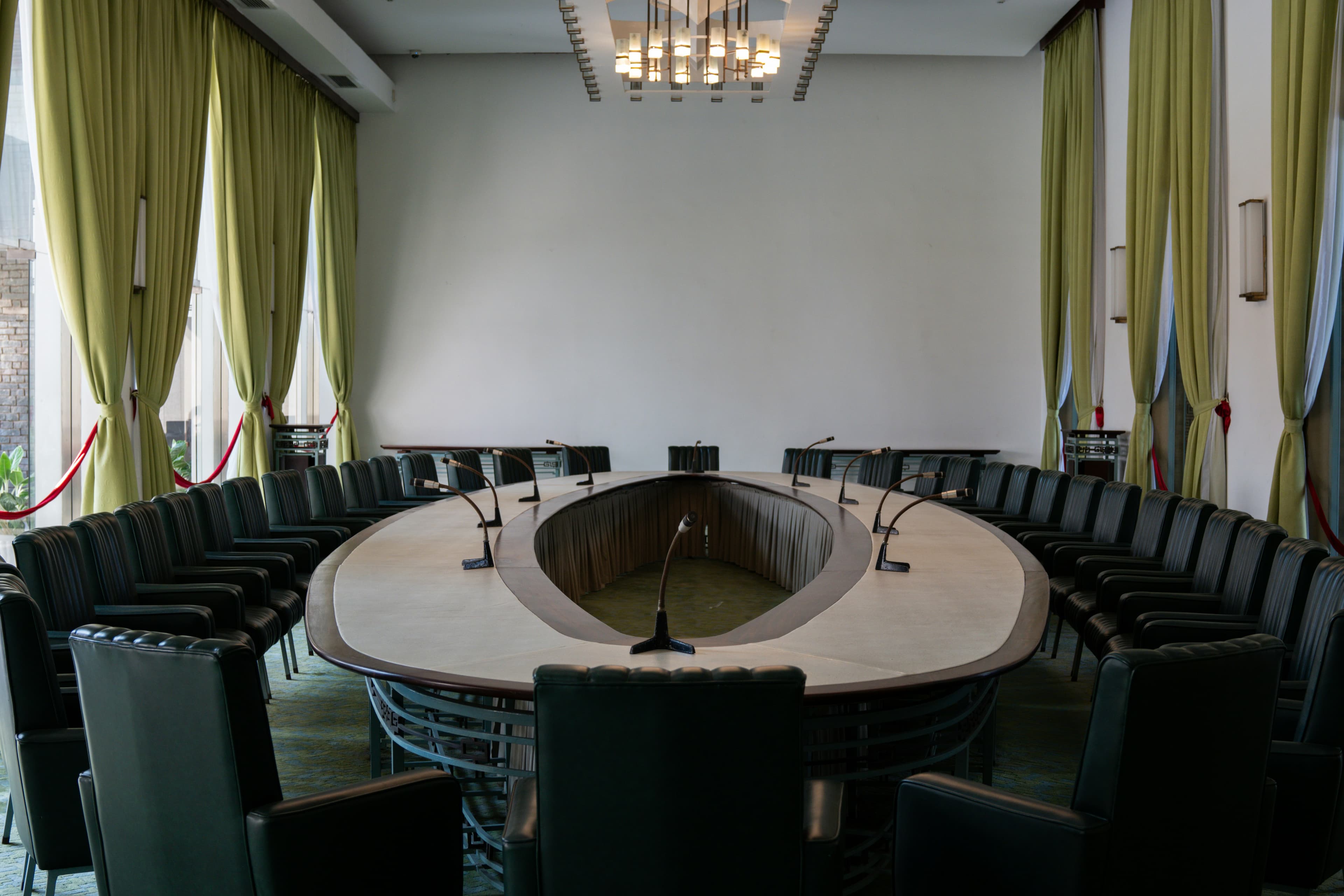 An empty roundtable conference room set for a formal session