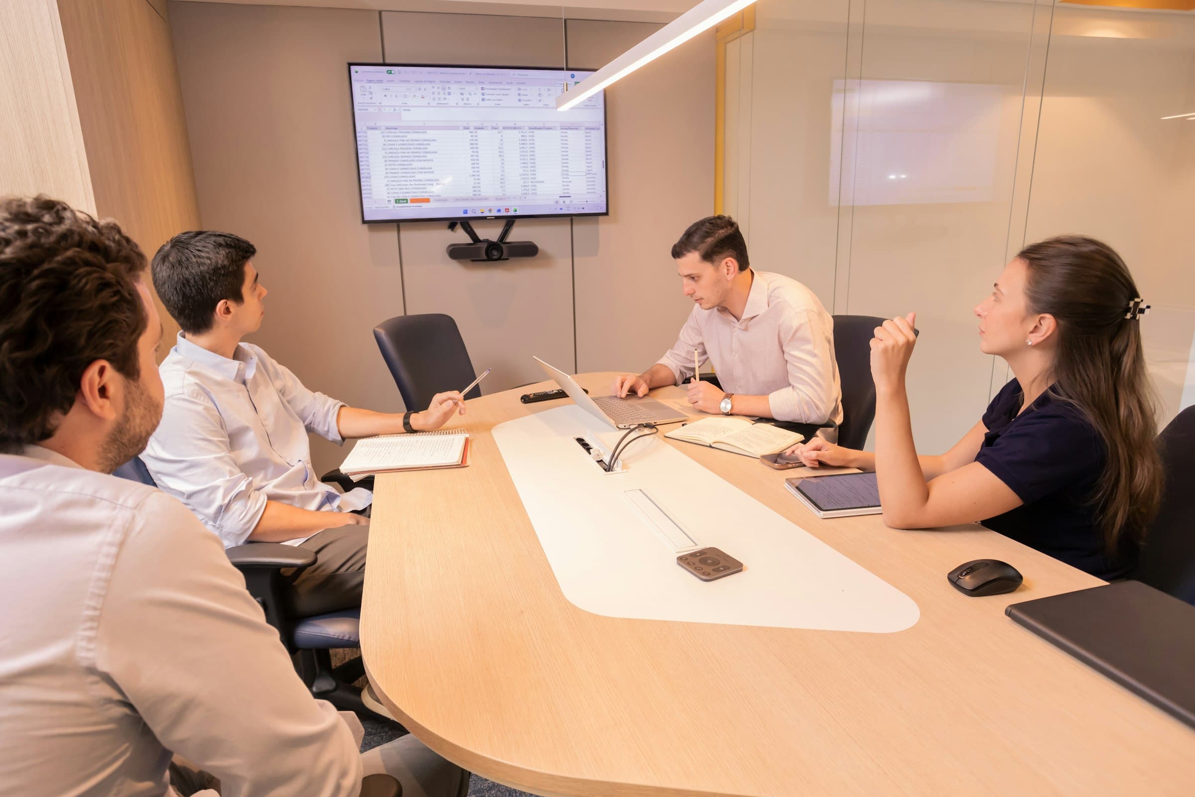 A legal team reviewing tool performance data together in a modern conference room